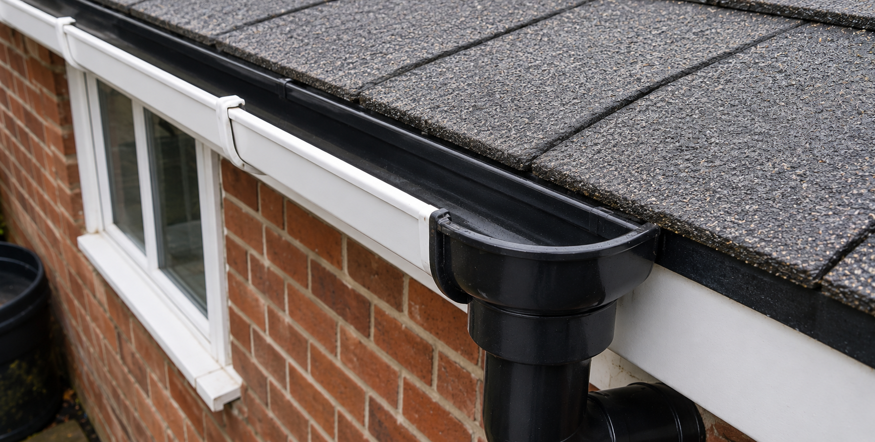 After — Same Birmingham property after professional gutter cleaning — channel fully cleared, downpipe flowing freely, all warning signs resolved